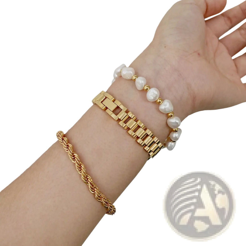 Elegant gold titanium link bracelet with pearl accents shown on wrist featuring gold-toned rope chain design