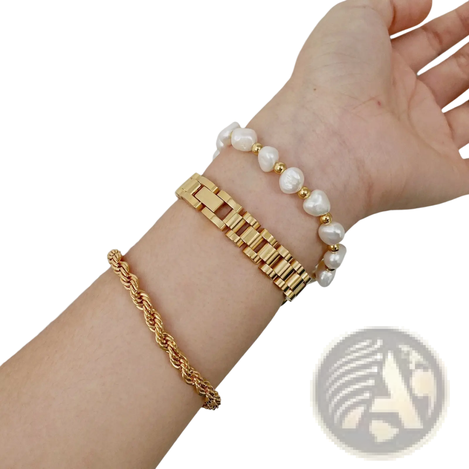 Elegant gold titanium link bracelet with pearl accents shown on wrist featuring gold-toned rope chain design