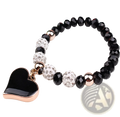 Elegant heart charm beaded elastic bracelet set featuring black and rose gold beads with a heart-shaped pendant