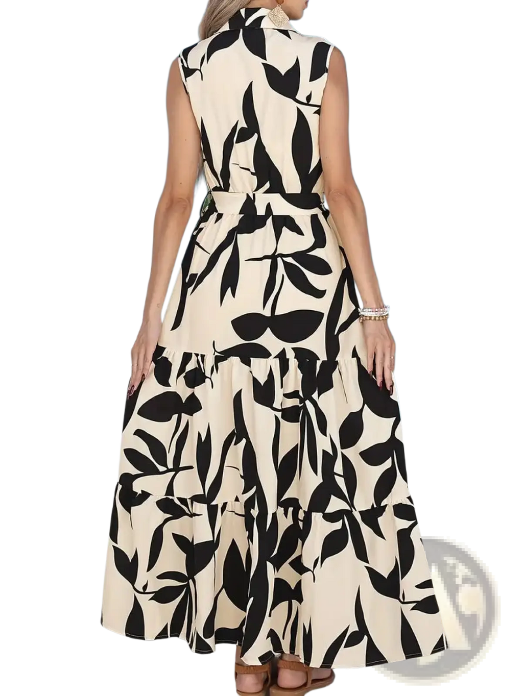 Elegant leaf print sleeveless tiered maxi dress in cream with black leaf pattern and fitted waistband