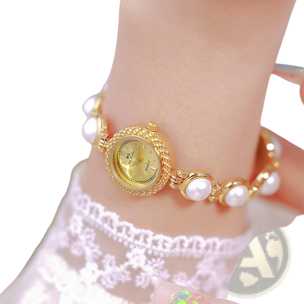 Elegant pearl bracelet quartz watch for women with gold-toned pearl accents and ornate case with matching bracelet links