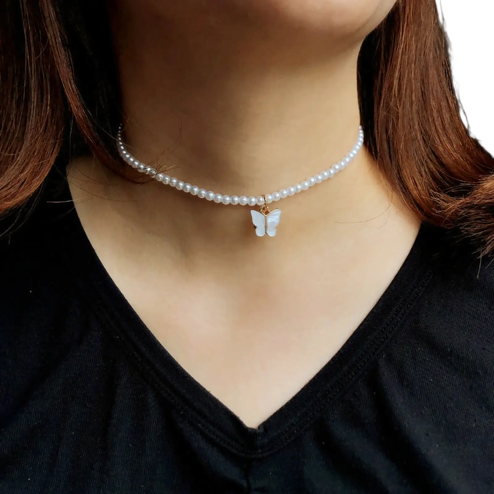 Elegant pearl butterfly charm choker necklace featuring delicate white pearls and a translucent white butterfly pendant