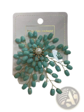 Elegant pearl and crystal floral brooch accessory with a delicate mint green beaded flower and gold toned wire detailing