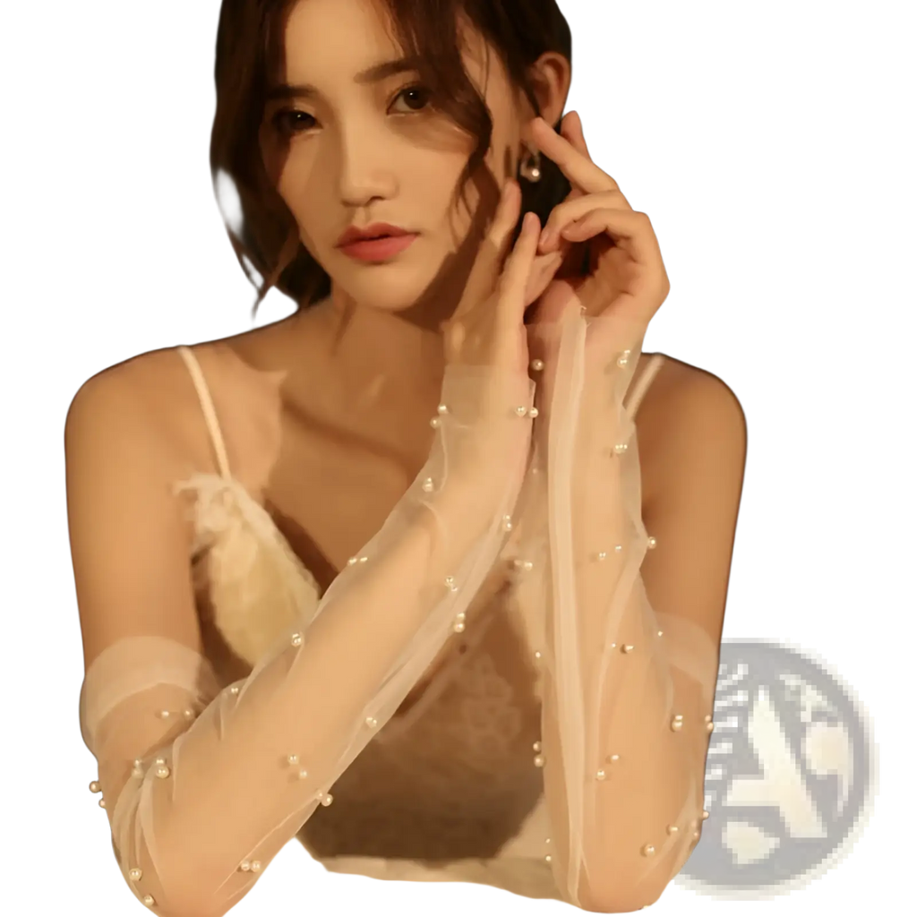 Elegant pearl embellished sheer off-white mesh bridal gloves with delicate pearls along each finger shown from the back
