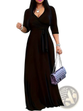 Black satin wrap dress with three quarter sleeves and cinched waist belt shown from the front