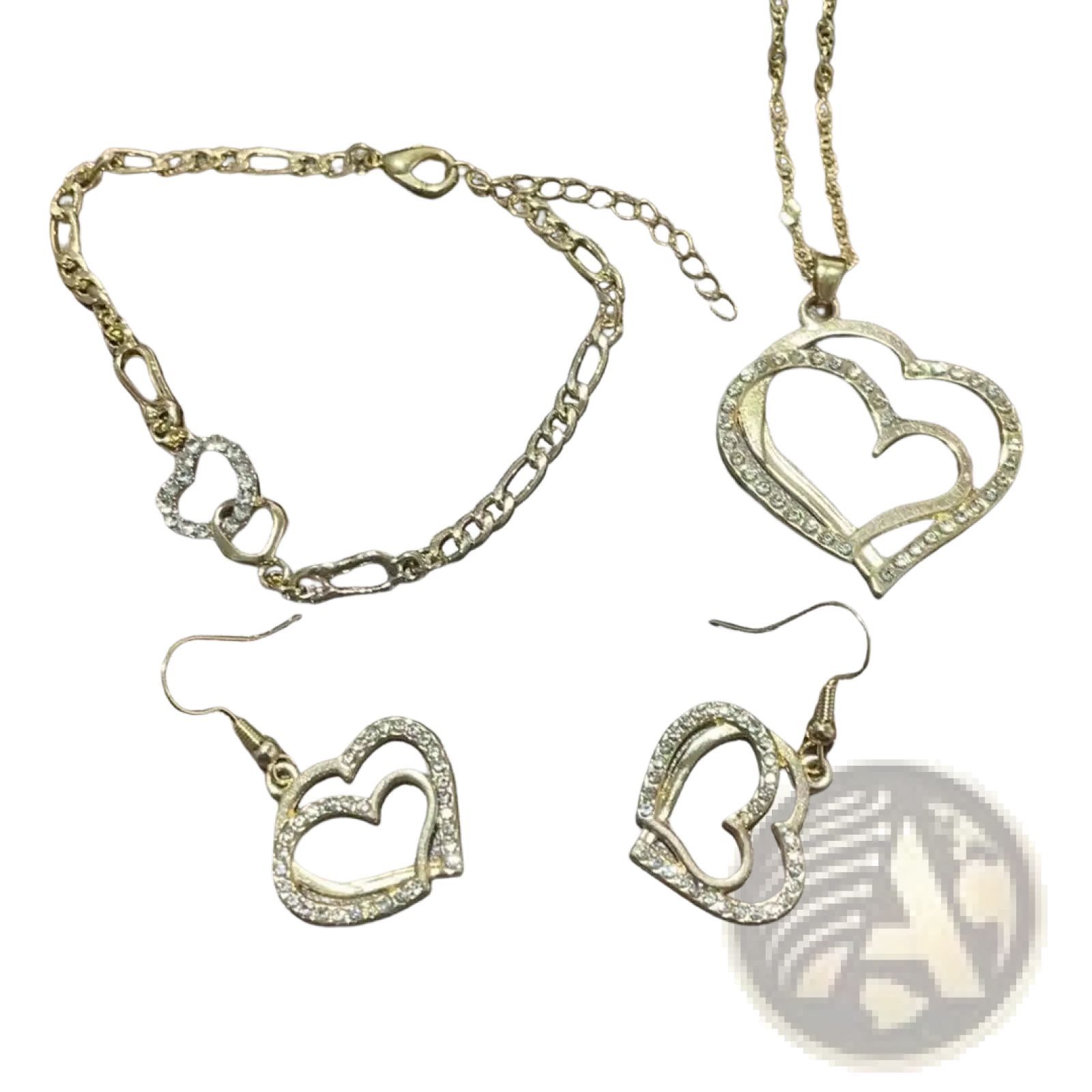 Gold-toned heart-shaped jewelry set with necklace bracelet and earrings featuring sparkling rhinestone accents