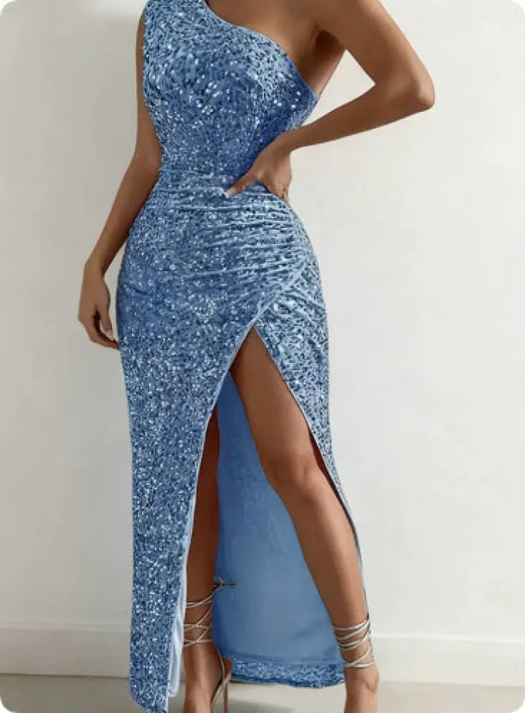 A shimmering blue sequined one shoulder maxi dress with ruched detailing and a high slit