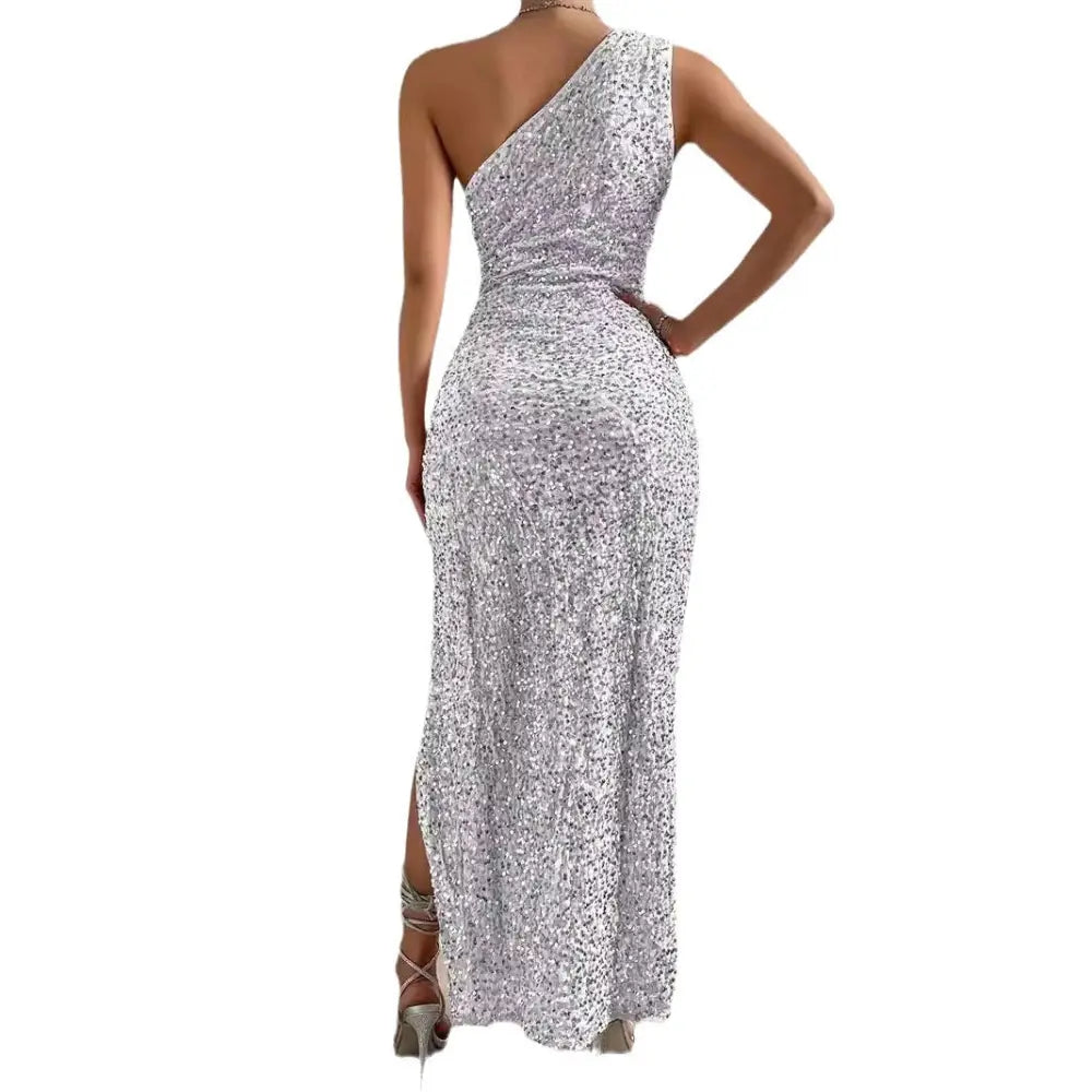 A shimmering silver sequined one shoulder maxi dress with a high slit for elegant evening wear