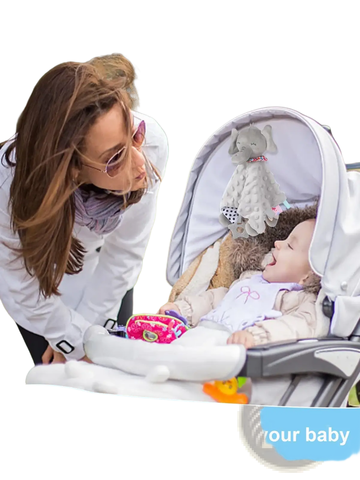 White baby stroller with a soft plush elephant comforter blanket hanging from the canopy for infant comfort