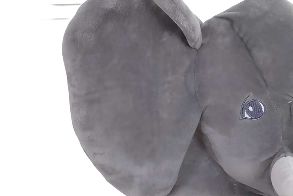 A plush gray elephant toy with soft velvety fabric and embroidered eyes ideal as a kids stuffed animal pillow