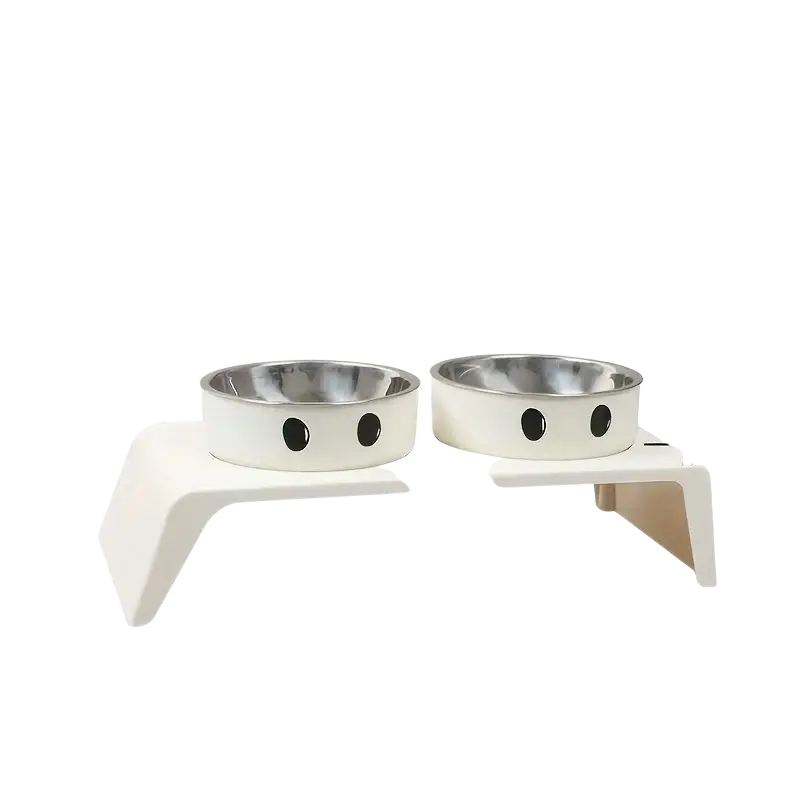 White elevated dog feeder with two stainless steel bowls featuring black circular eyes on the exterior