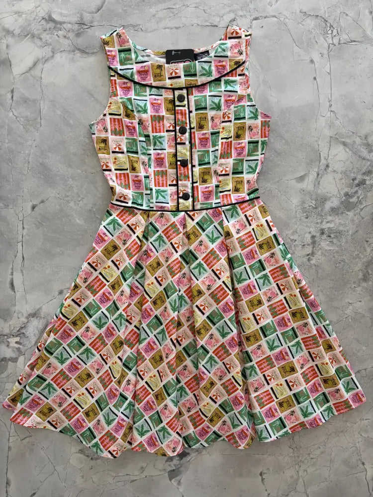 Elizabeth dress sleeveless cotton a-line with vintage stamp print in pink green beige and black trim on neckline and waistband