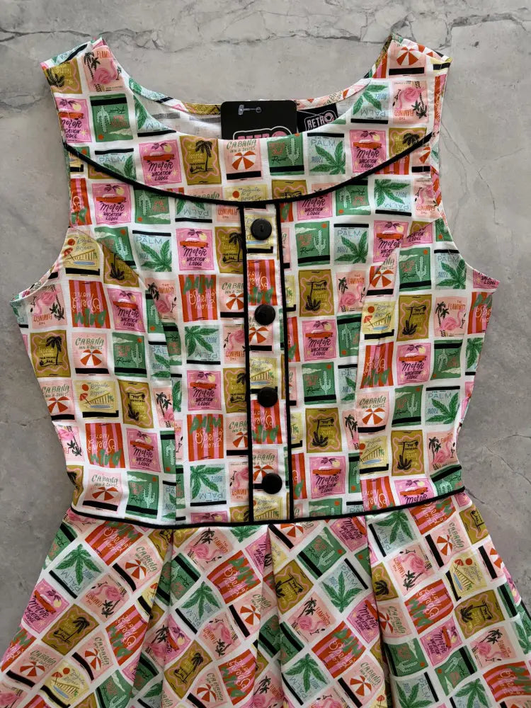 Elizabeth dress in paradise vintage stamp print cotton a-line featuring a sleeveless retro tropical soda can design