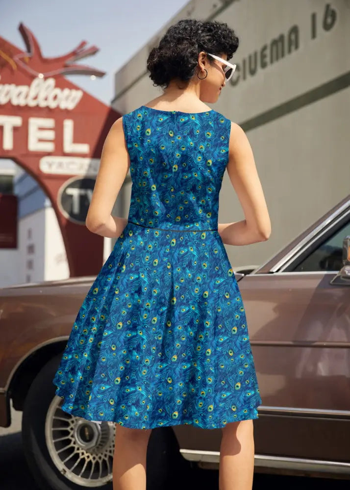 Elizabeth peacock print vintage cotton midi dress sleeveless knee-length vibrant blue fabric with peacock feather pattern