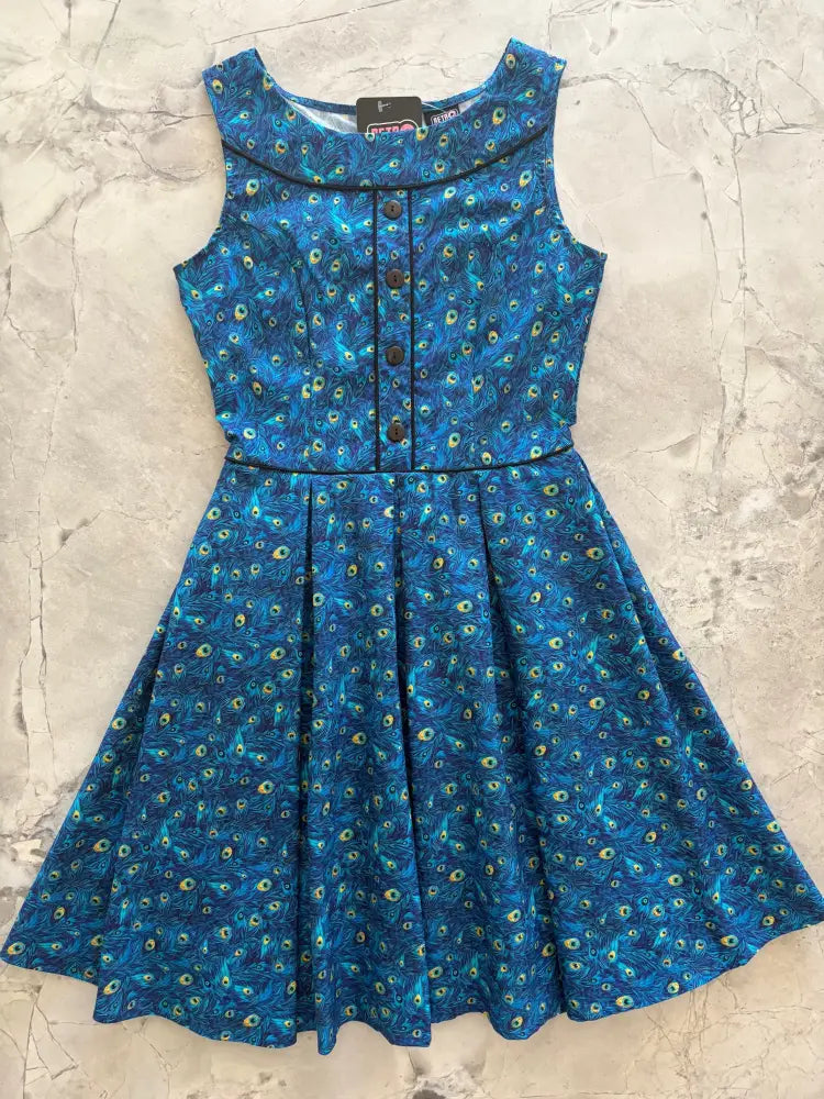 A sleeveless blue peacock feather print vintage cotton midi dress with button front and flared skirt