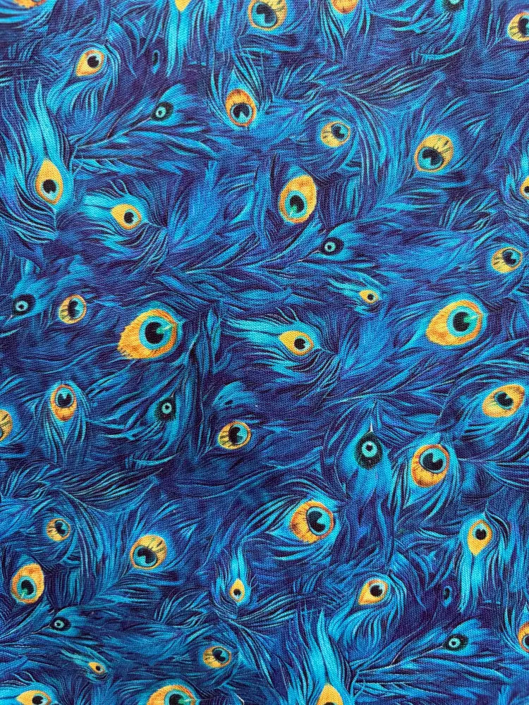 Blue vintage cotton midi dress featuring dense peacock feather print with vibrant yellow and black eye markings