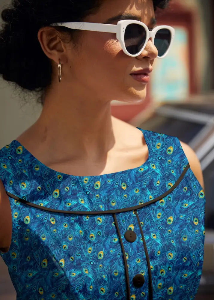 Elizabeth peacock print vintage cotton midi dress with blue peacock feathers sleeveless black trim and brown buttons