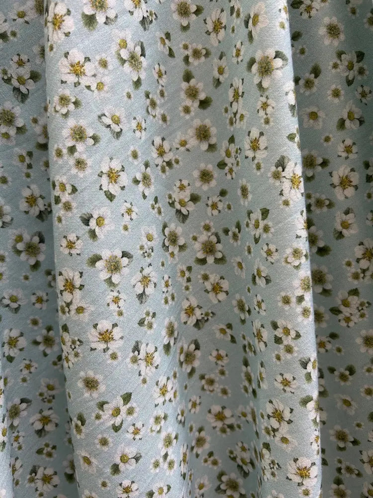 Elizabeth petite floral cotton vintage flare dress in light blue with a delicate white flower and green leaf pattern