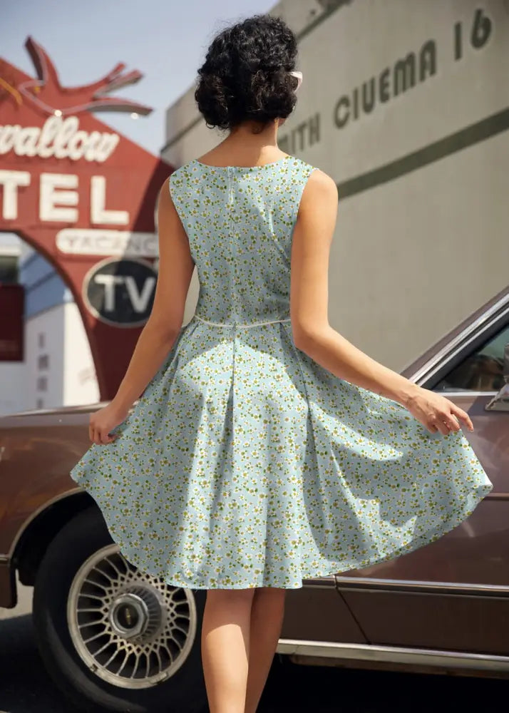 A light blue cotton Elizabeth petite floral vintage flare dress with a fitted bodice and delicate green pattern