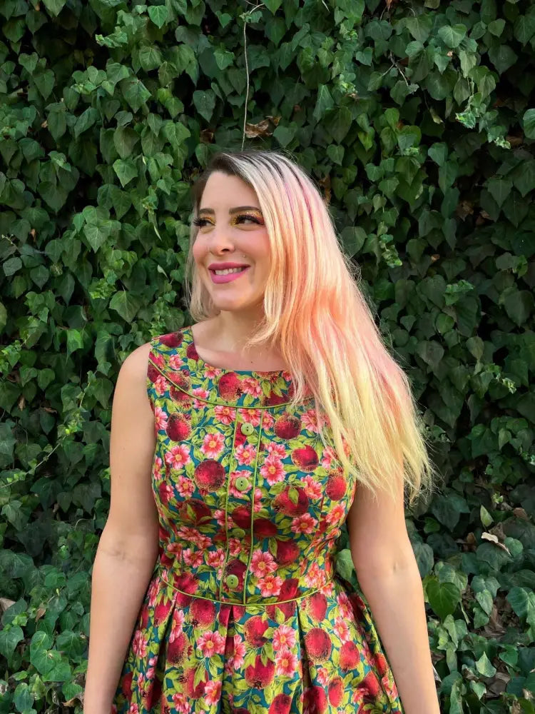 A vibrant Elizabeth pomegranate floral cotton a line vintage dress with bold red and pink blossoms on green