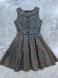 Elizabeth vintage blue floral cotton a-line dress with pockets featuring dark teal base and black trim accents
