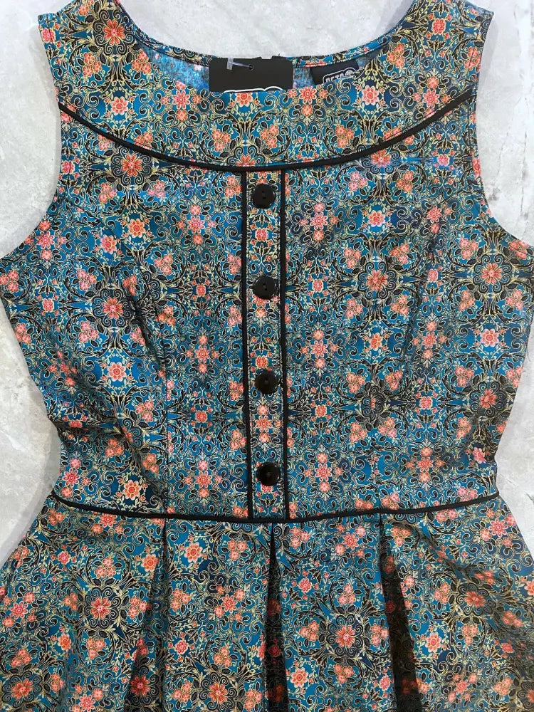Elizabeth vintage blue floral cotton sleeveless a-line dress with coral and gold patterns, black trim, and pockets