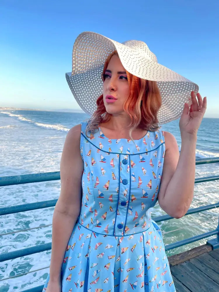 Elizabeth light blue floral vintage cotton A-line dress with a sailor-themed print and navy button details sleeveless design
