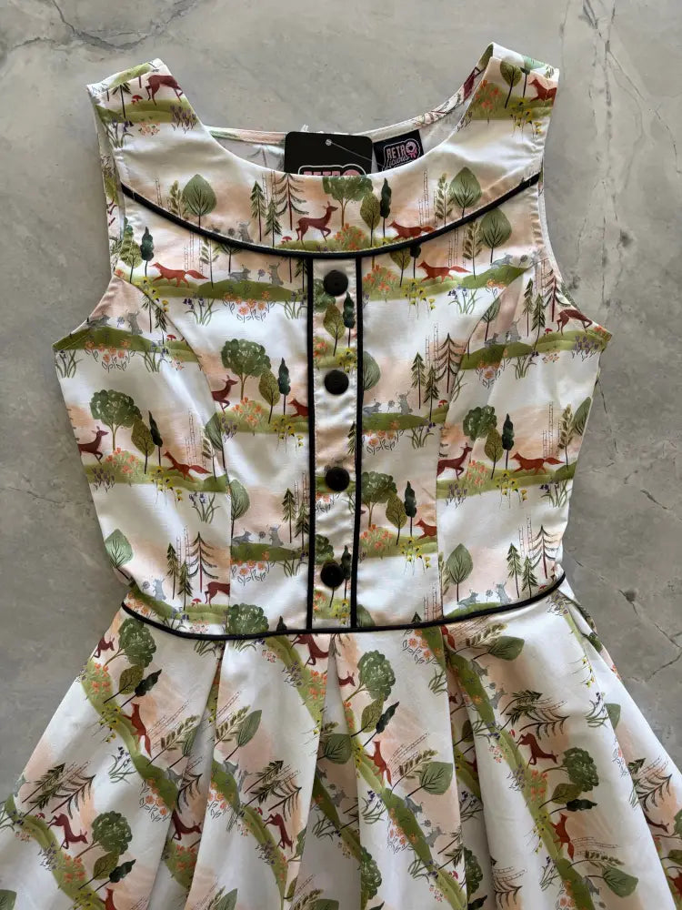 Sleeveless white cotton Elizabeth dress with woodland animal print featuring foxes deer and trees and black trim