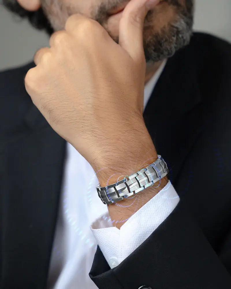 Ellipsemax silver titanium magnetic link bracelet for men in silver-toned stainless steel worn on a man’s wrist
