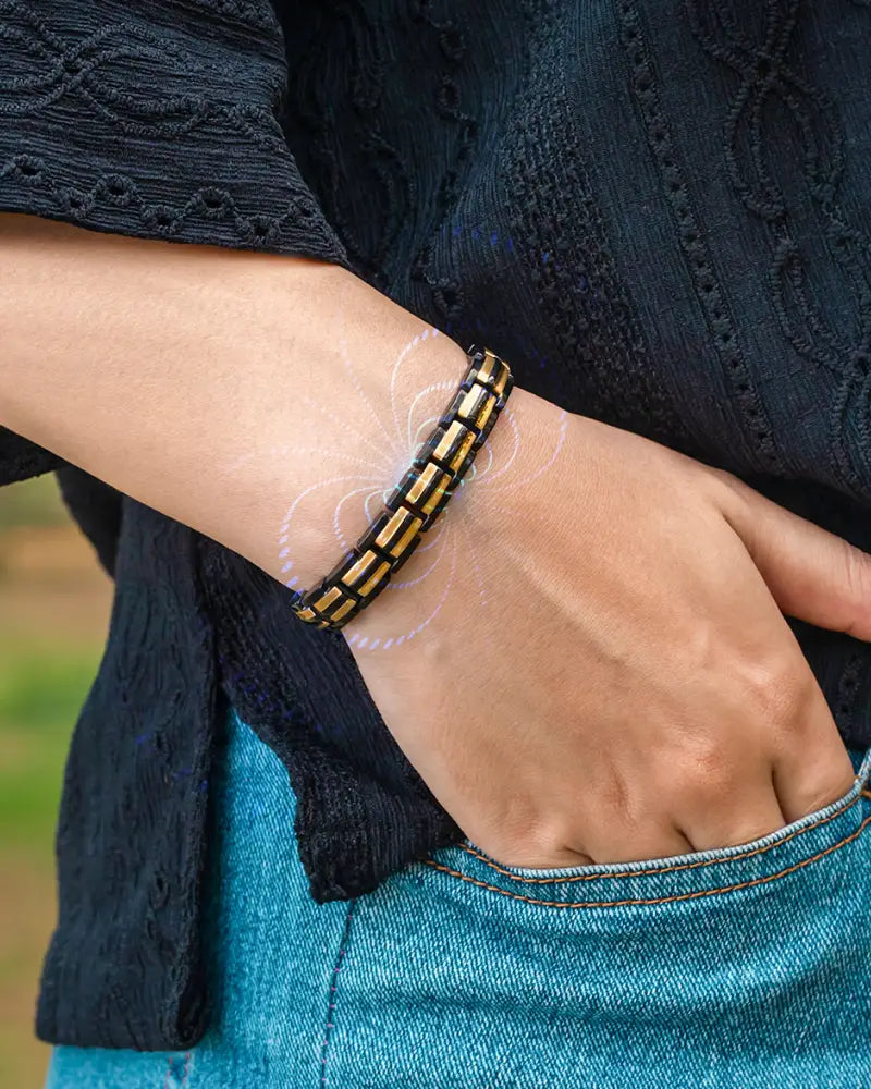 Ellipsemax black and gold segmented magnetic bracelet with beaded interlocking design worn on wrist