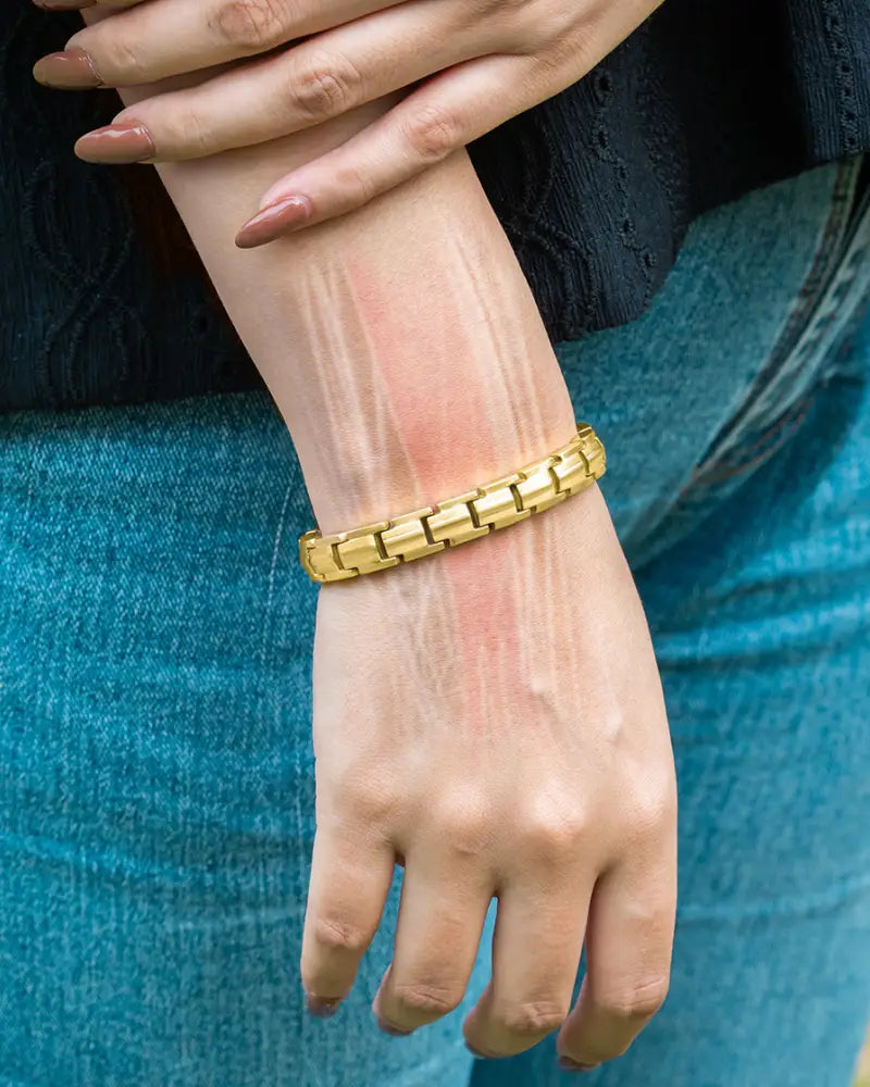Gold-toned interlocking link ellipsemax gold titanium magnetic therapy bracelet for women worn on a wrist