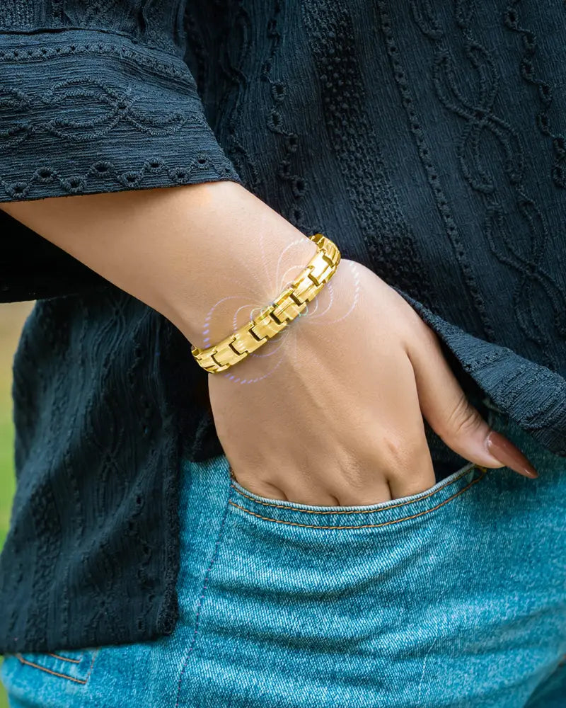 Ellipsemax gold titanium magnetic therapy bracelet for women worn on wrist with gold-toned interlocking link design