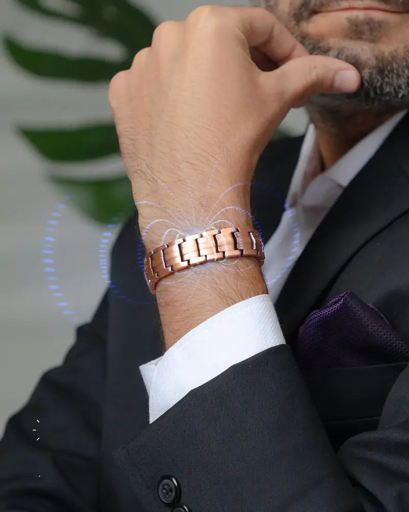 Ellipsemax rose gold pure copper magnetic link bracelet with copper-toned interlocking links on a man’s wrist