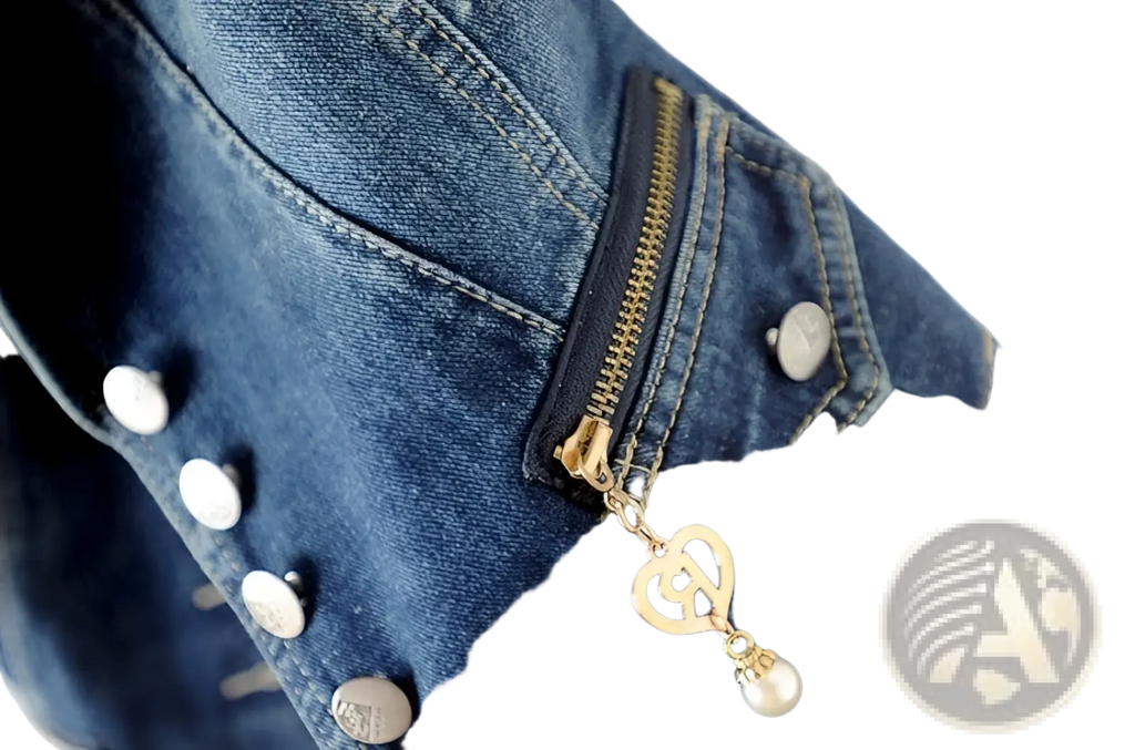 A dark blue tailored denim vest with a gold-tone heart-shaped zipper pull and a dangling pearl charm on the front pocket