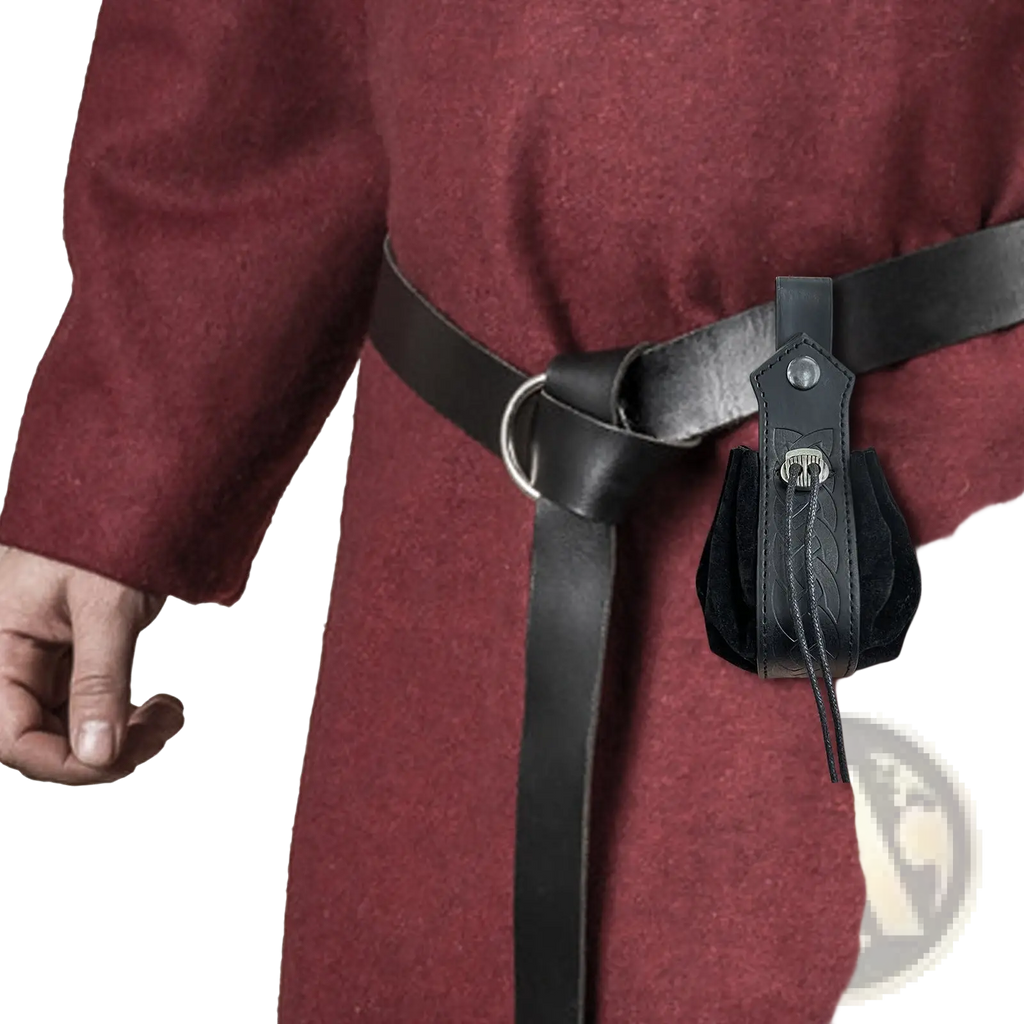 Black leather embossed celtic knot viking sling bag with silver skull clasp and decorative stitching attached to black belt