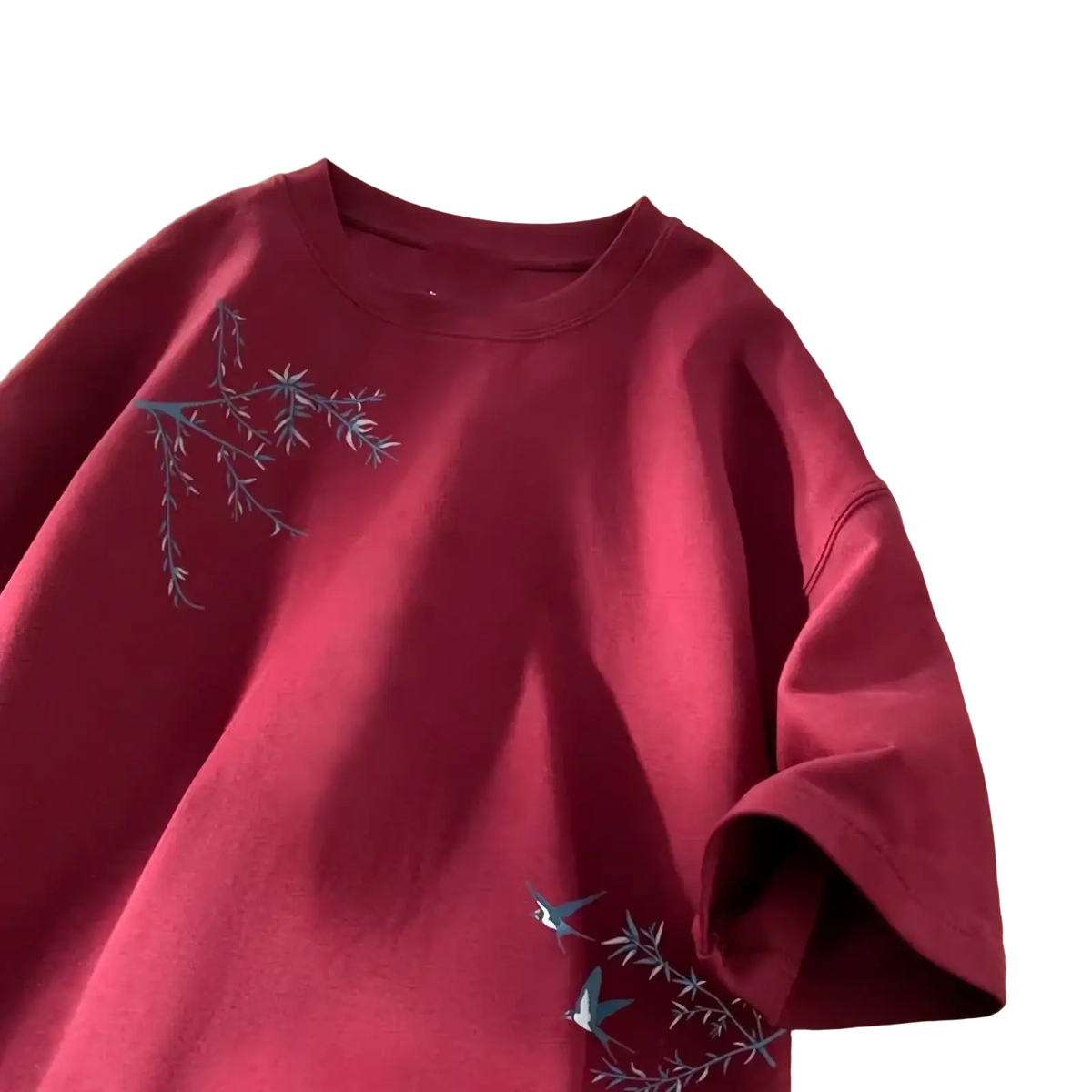 A maroon cotton oversized t-shirt with delicate gray embroidered branches and birds on the front