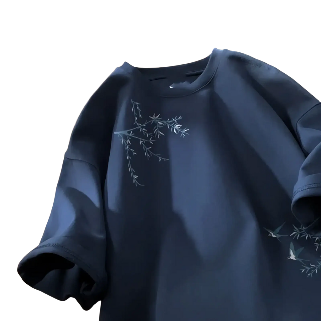 Navy blue cotton embroidered bird oversized t-shirt with delicate white branches and leaves on the chest