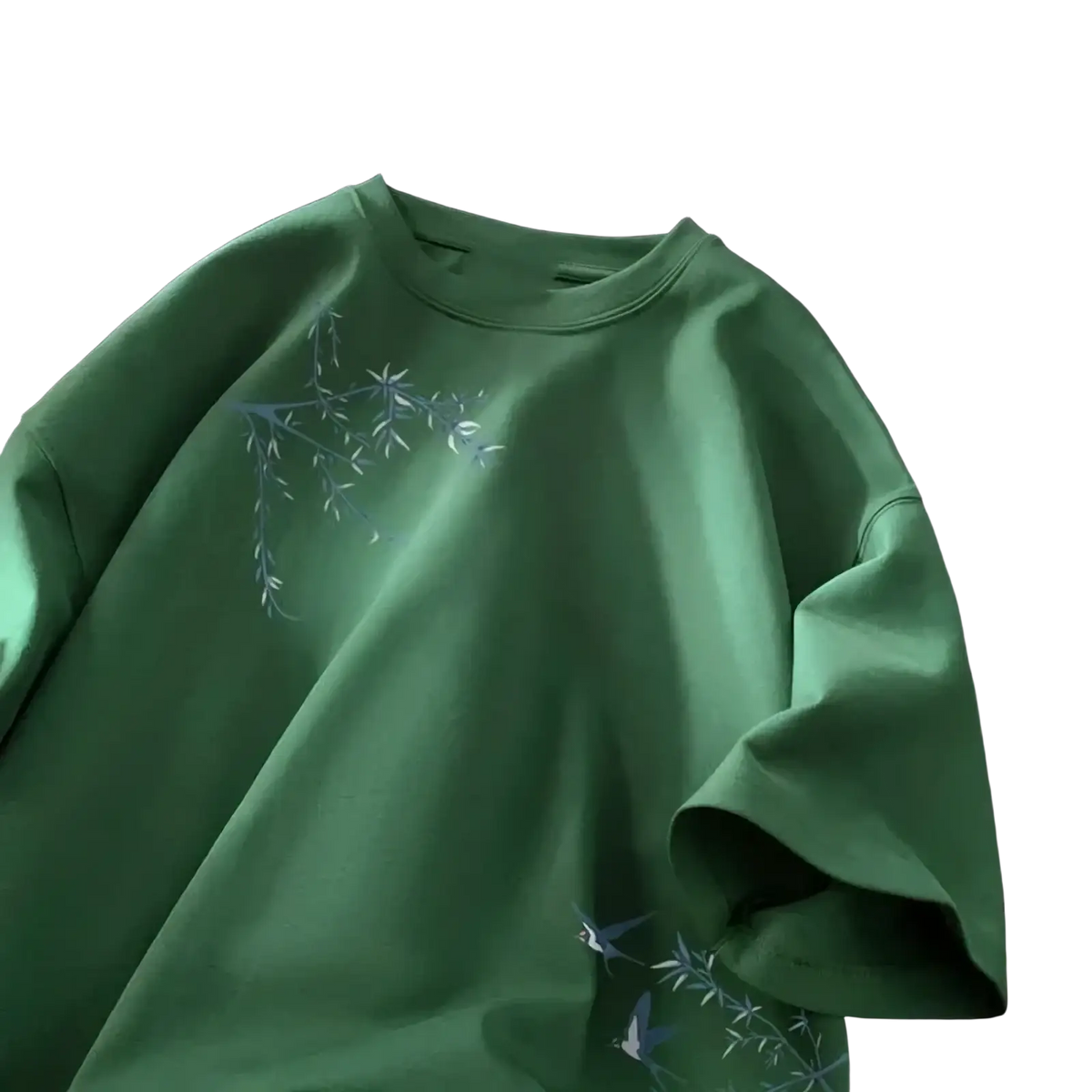 A soft green oversized cotton t-shirt embroidered with delicate blue bamboo and bird motifs