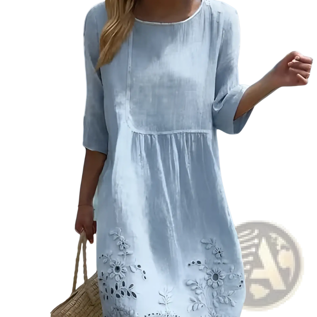 Light blue linen umbrella dress with delicate floral embroidery along the scalloped hem