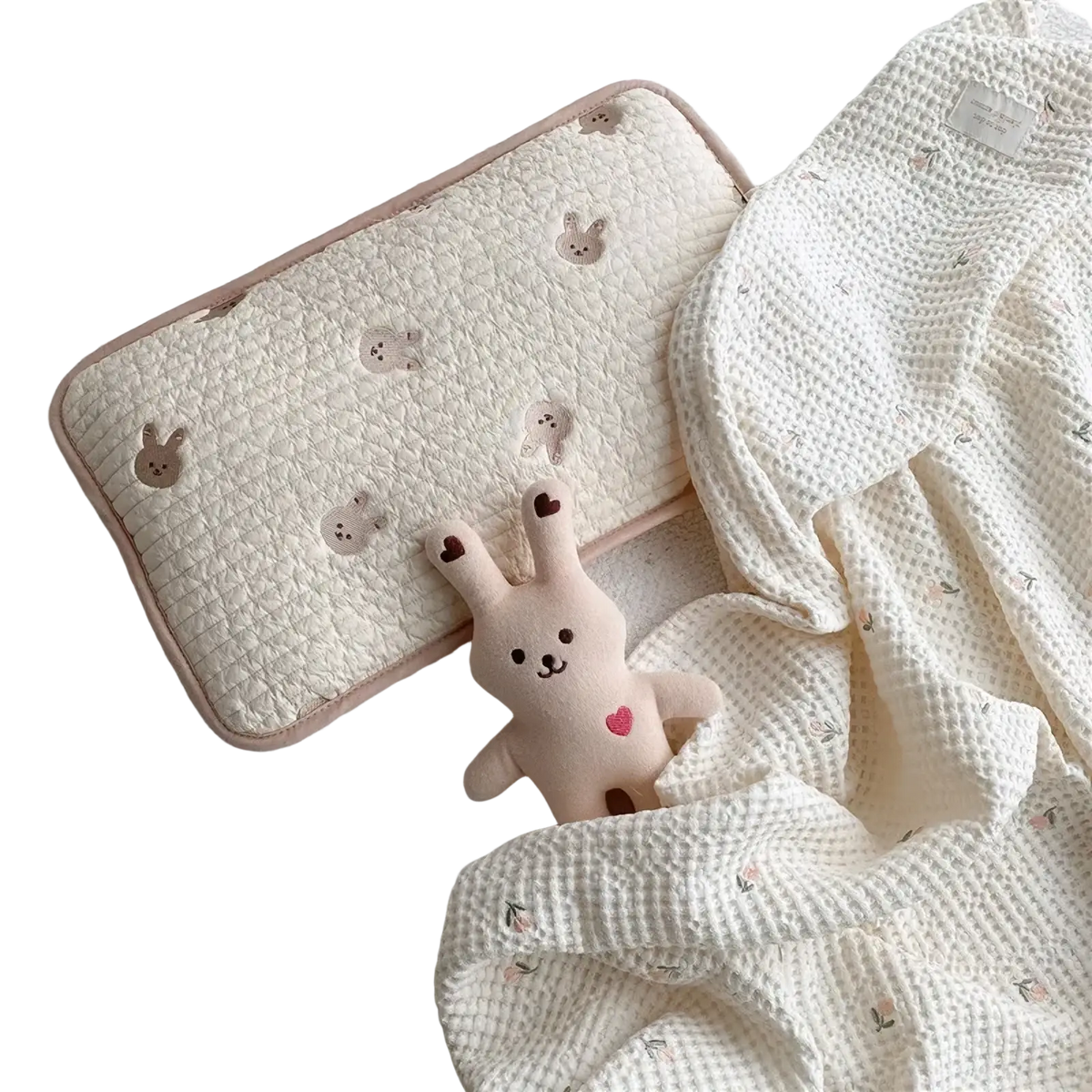 Embroidered cotton baby pillow with cream quilted fabric soft pink trim and subtle bunny embroidery motifs
