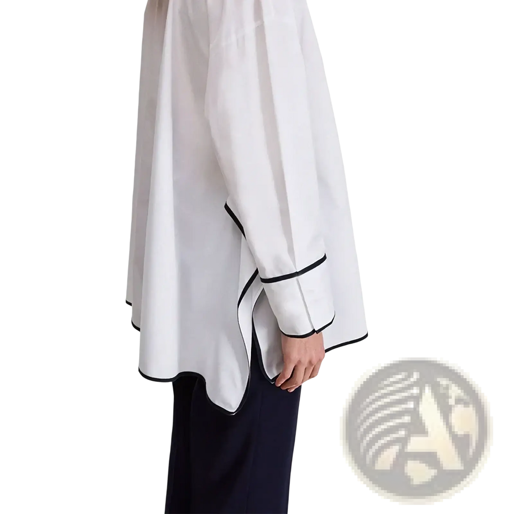 Embroidered cotton blouse with black trim along cuffs and hem in white featuring a relaxed fit