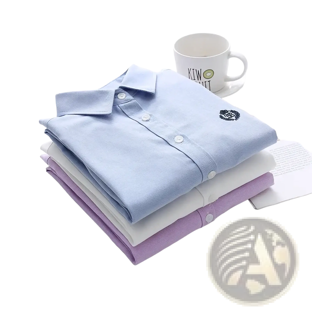 A neatly folded light blue embroidered cotton casual long sleeve blouse top with a subtle crest on the chest