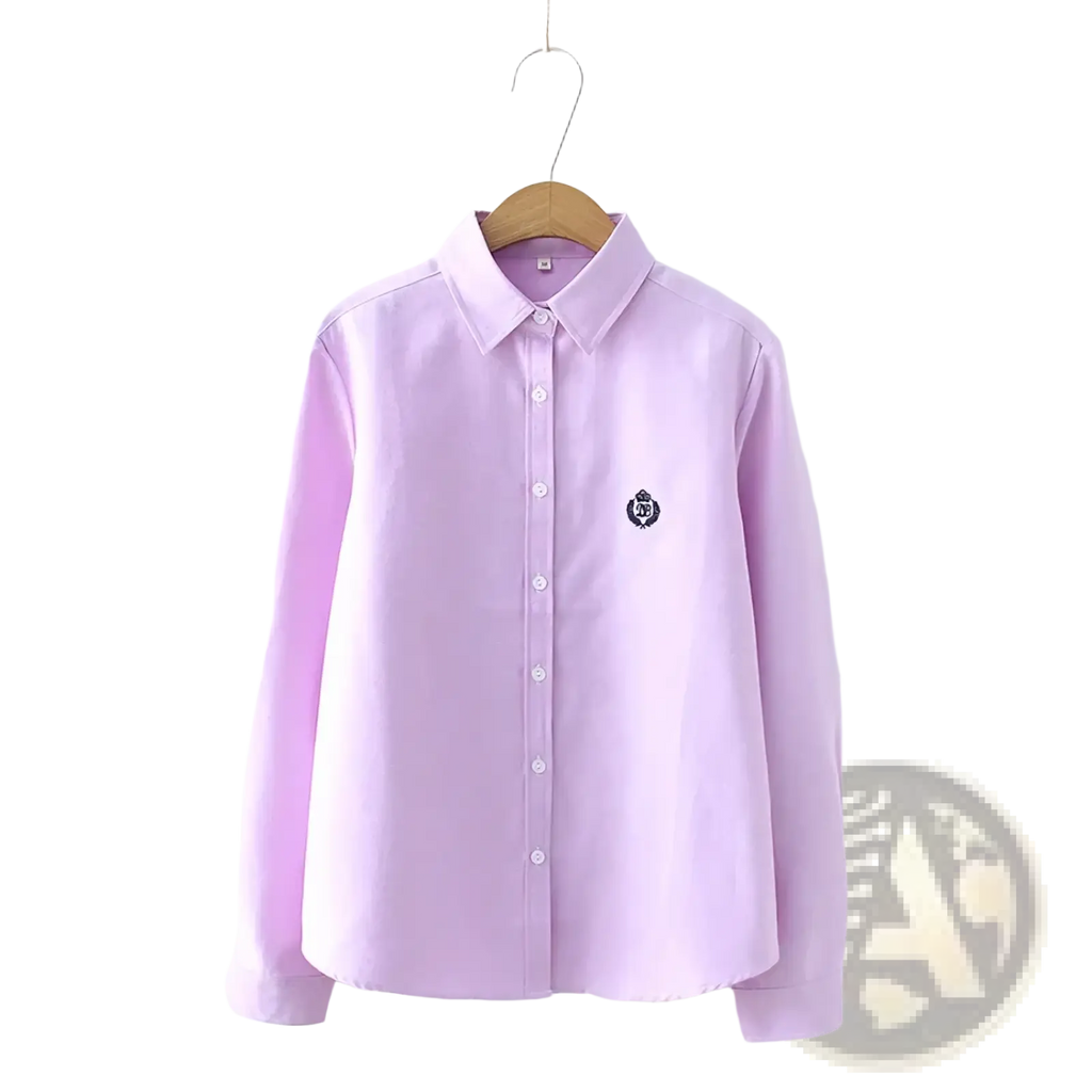 A soft lavender cotton embroidered long sleeve blouse with button-up front and subtle logo on left chest
