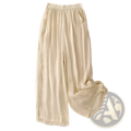 Cream-colored embroidered cotton linen wide leg pants with lightweight fabric and delicate lace trim along side seams