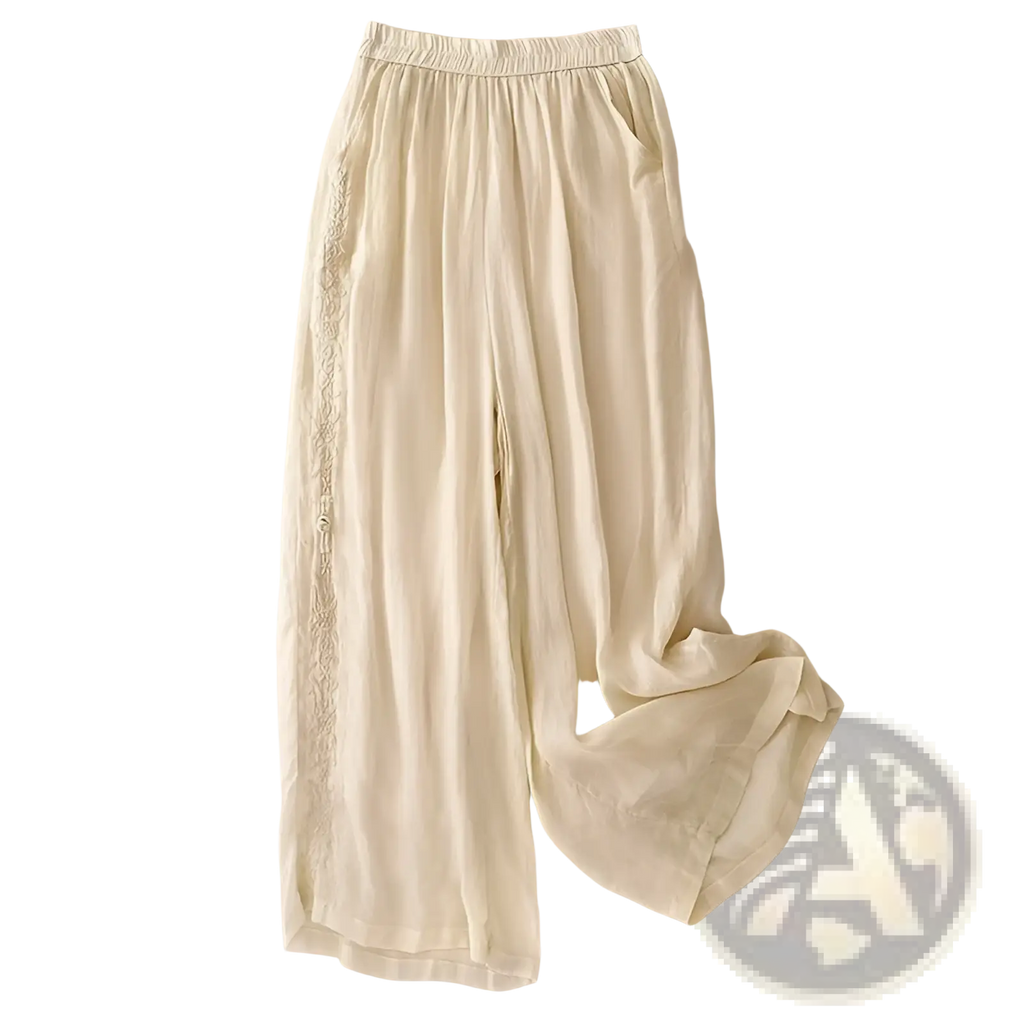 Cream-colored embroidered cotton linen wide leg pants with delicate lace trim along the side seams