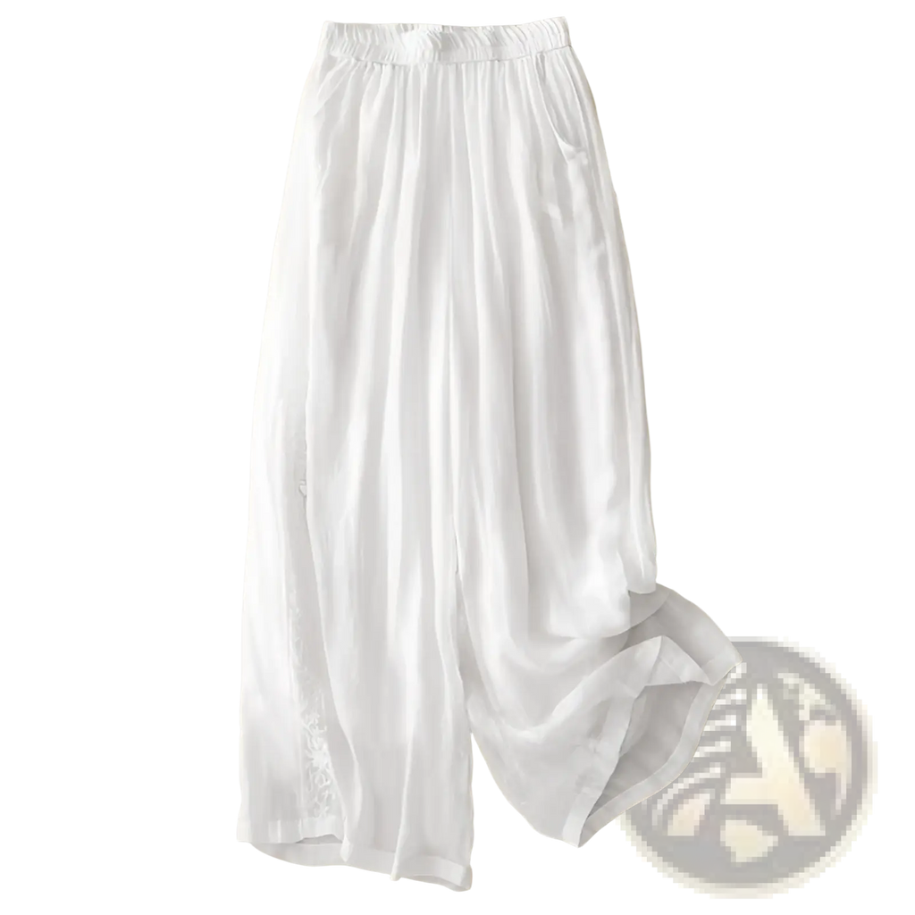 White embroidered cotton linen wide leg pants with elastic waistband and subtle side embroidery visible from the front
