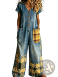 Blue denim embroidered jumpsuit with wide leg, short sleeves, yellow and brown plaid patch pockets, and pixelated leg pattern