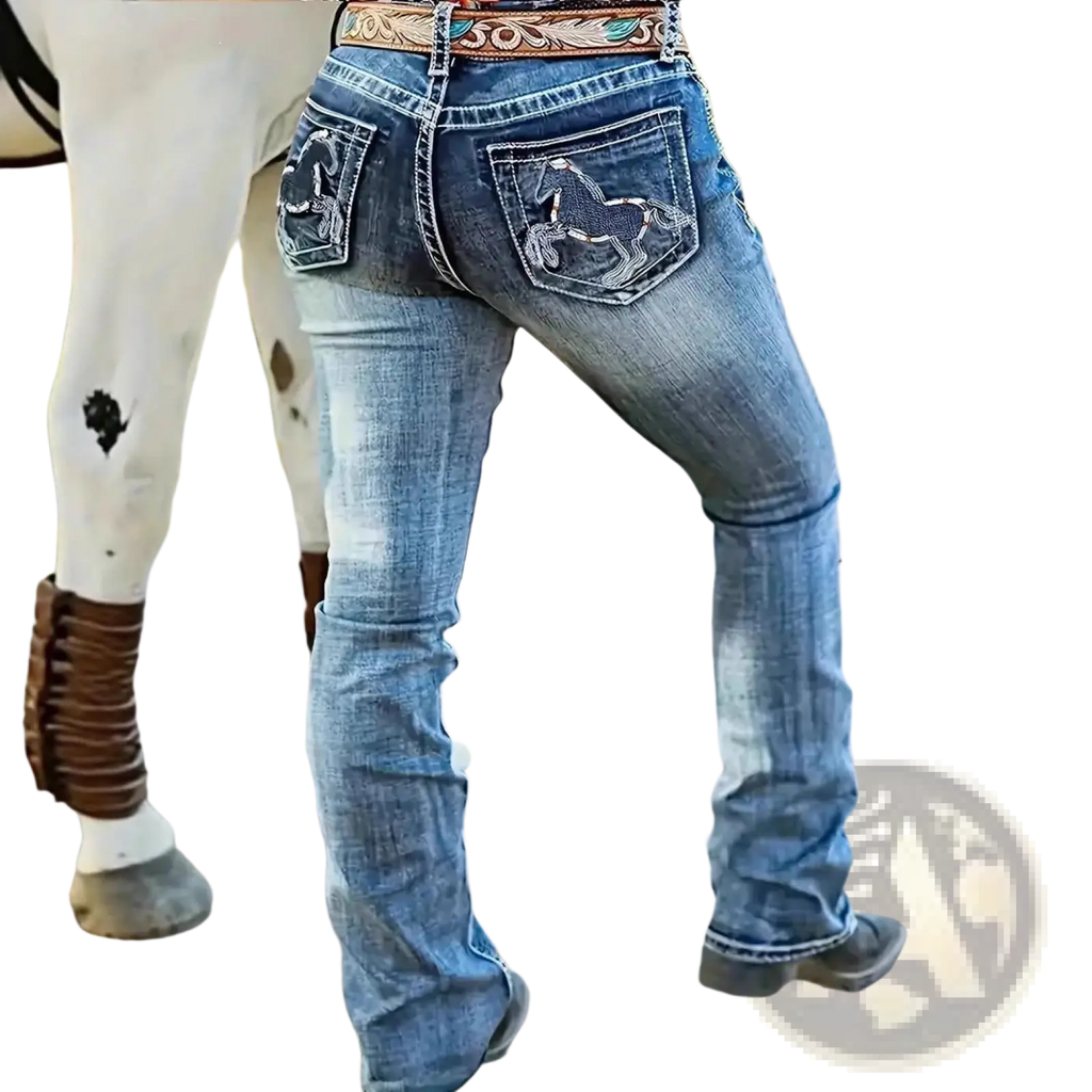 Back side of blue denim straight leg jeans with embroidered horse designs on pockets and floral decorative belt