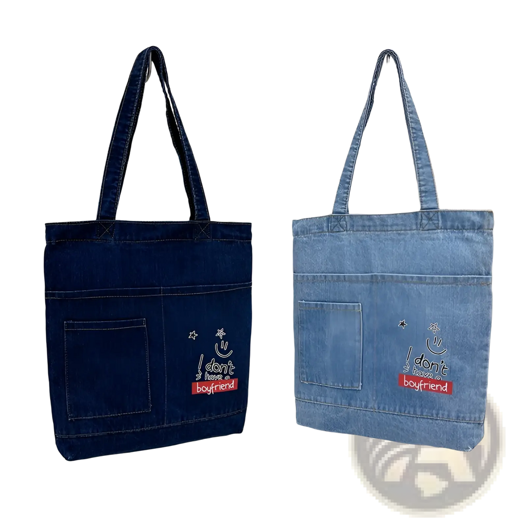 Two denim tote bags in dark and light blue with embroidered slogan and soft handles for casual use