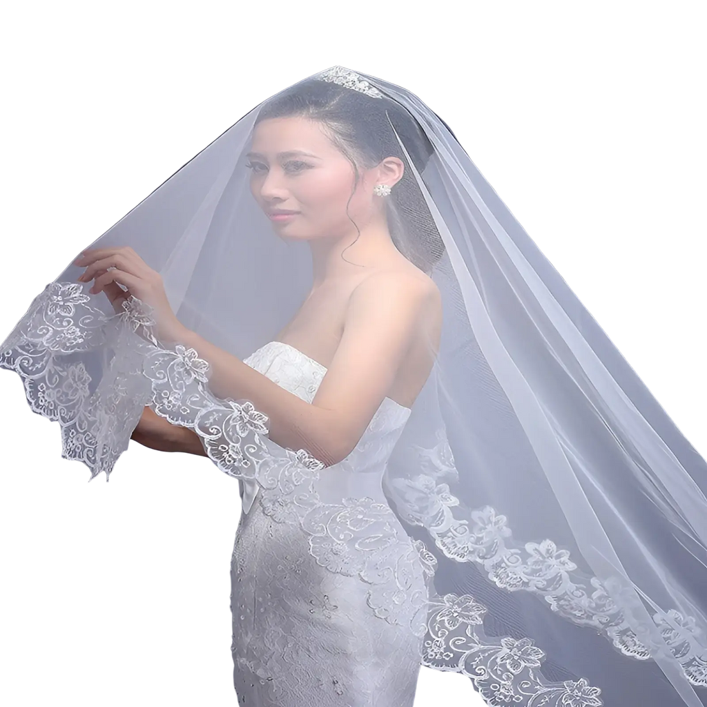 Delicate white lace embroidered floral cathedral wedding veil with intricate edges draped over the bride’s shoulders
